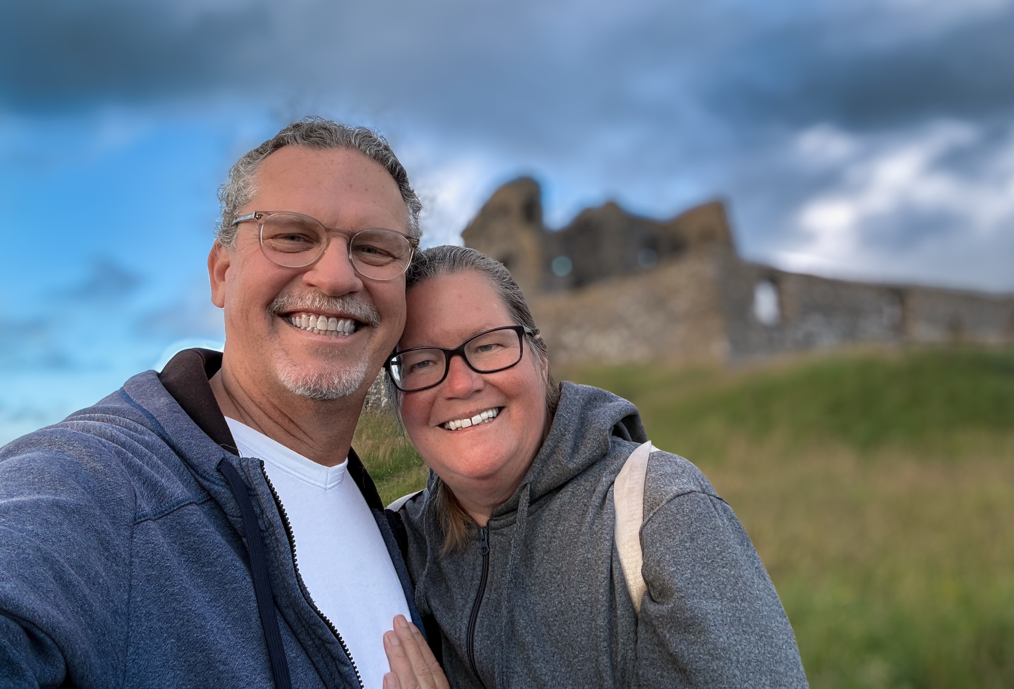 David and Diane standing in front of the ruined walls of Auchindoun Castle in the cool twilight.