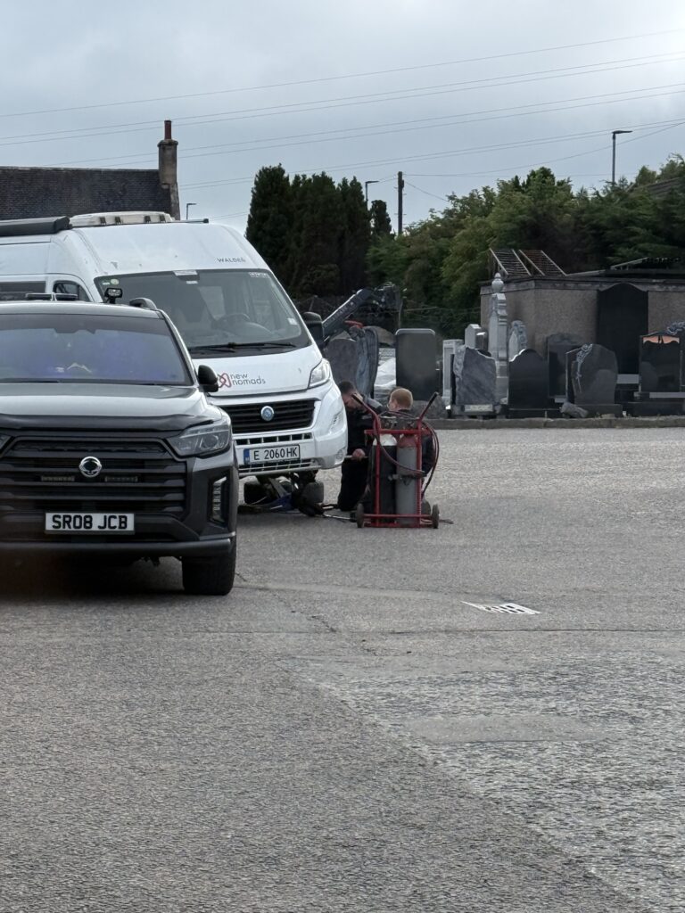 The front wheel of the van after the last lug nuts sheared off in the car park